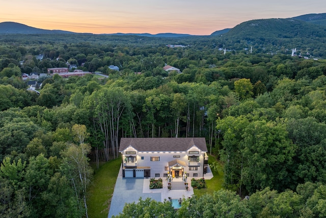 aerial view at dusk featuring a mountain view