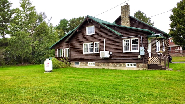 rear view of property with a yard