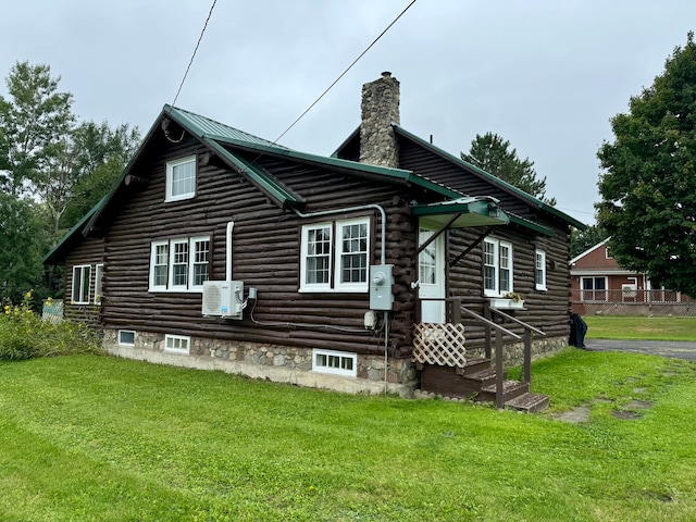 back of house featuring ac unit and a yard