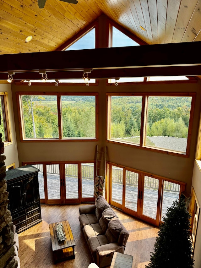 living room with french doors, a wealth of natural light, ceiling fan, and light hardwood / wood-style floors