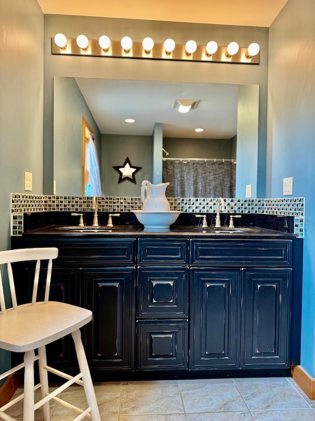 bathroom featuring tile patterned flooring, vanity, a shower with shower curtain, and backsplash