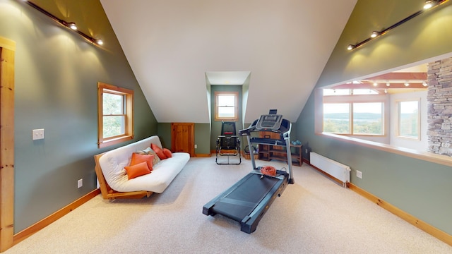 exercise area featuring vaulted ceiling, a baseboard radiator, and carpet