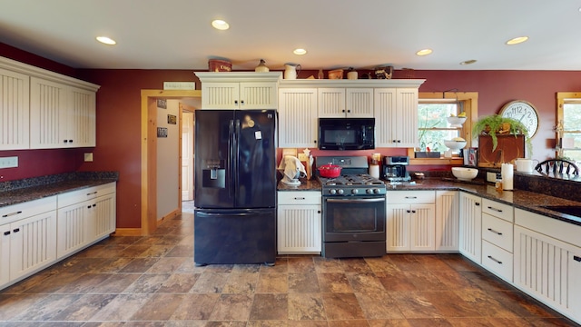 kitchen featuring black appliances and dark stone counters