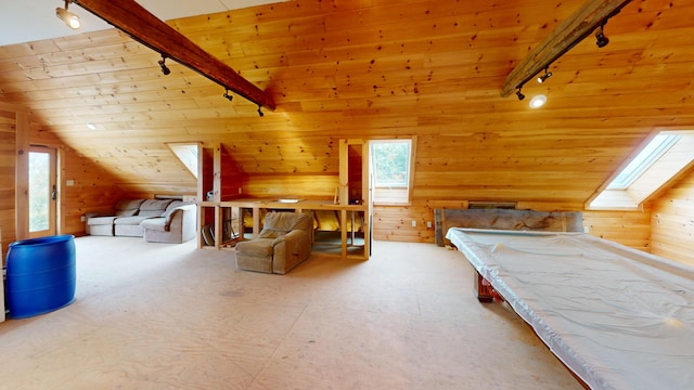 unfurnished bedroom featuring wood ceiling, rail lighting, wood walls, and lofted ceiling with skylight