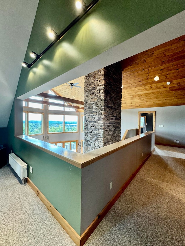 hallway featuring carpet and vaulted ceiling