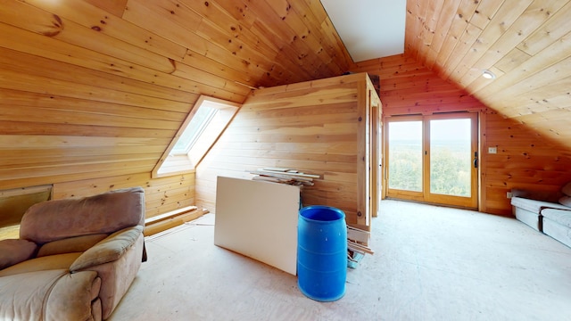 additional living space featuring wood ceiling, lofted ceiling with skylight, and wooden walls