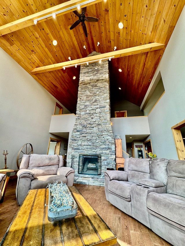 living room featuring a fireplace, wood ceiling, ceiling fan, wood-type flooring, and high vaulted ceiling