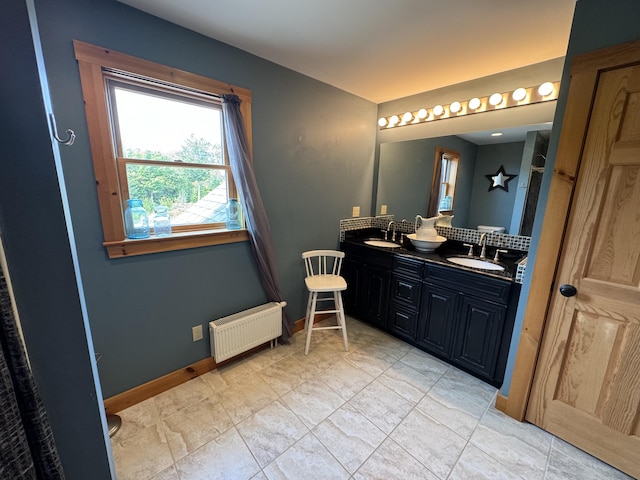 bathroom with radiator heating unit and vanity