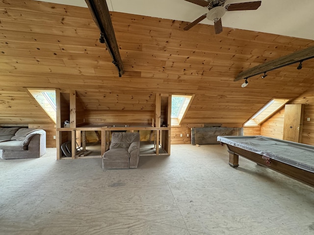 interior space featuring high vaulted ceiling, a skylight, ceiling fan, and wooden walls