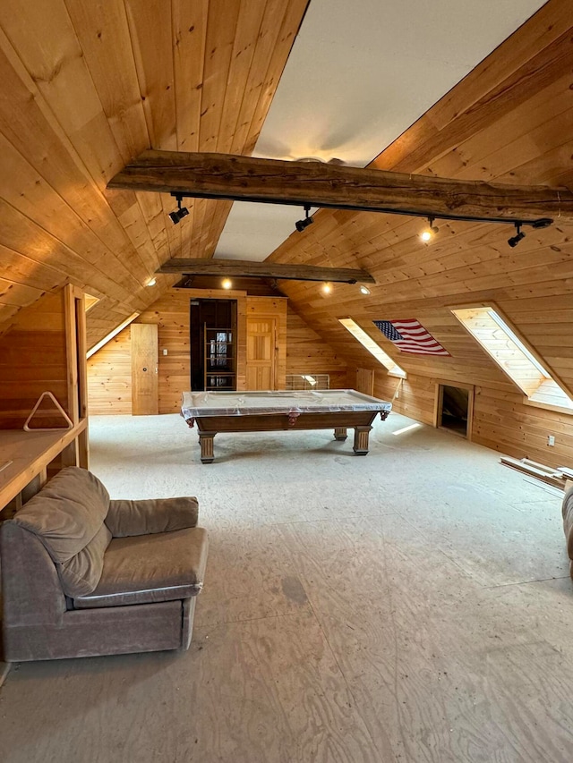 interior space with wood walls, pool table, and lofted ceiling with skylight