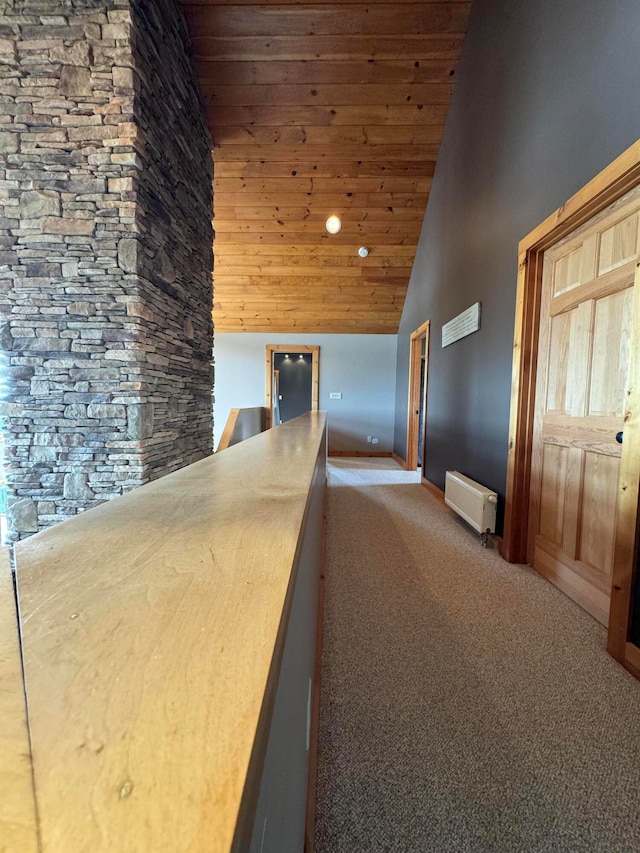 hall featuring wood ceiling, carpet flooring, and high vaulted ceiling