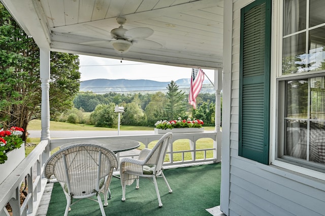 exterior space featuring lofted ceiling, wooden ceiling, a mountain view, and ceiling fan