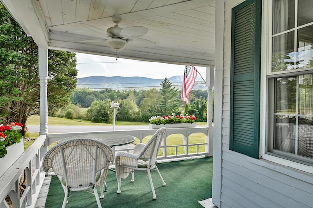 view of patio / terrace featuring a mountain view, a porch, and ceiling fan