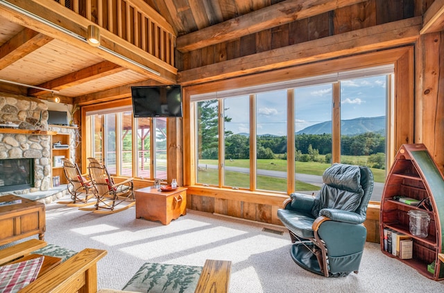 sunroom / solarium with a fireplace, vaulted ceiling with beams, wood ceiling, and visible vents