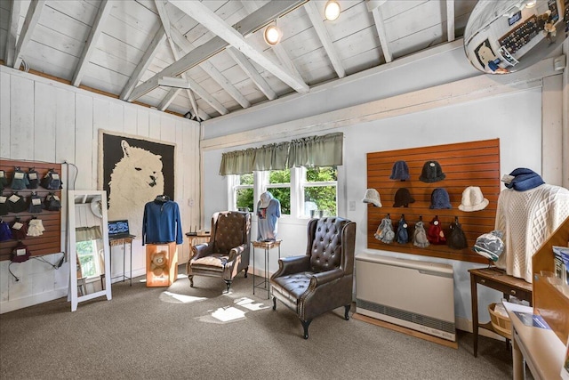 living area with a healthy amount of sunlight, carpet, and vaulted ceiling with beams