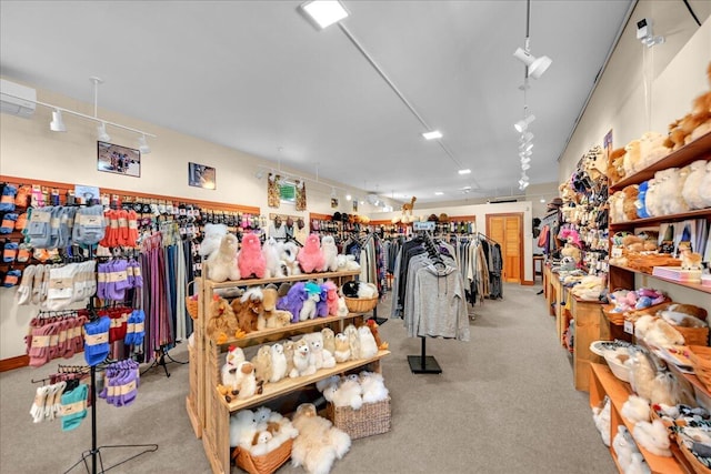 miscellaneous room featuring light colored carpet