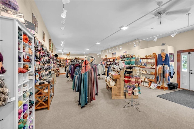 interior space with light carpet and ceiling fan