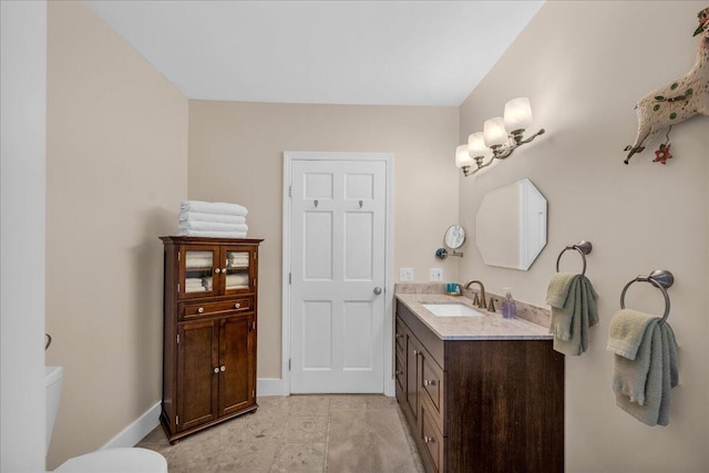 bathroom with vanity, toilet, and tile patterned flooring