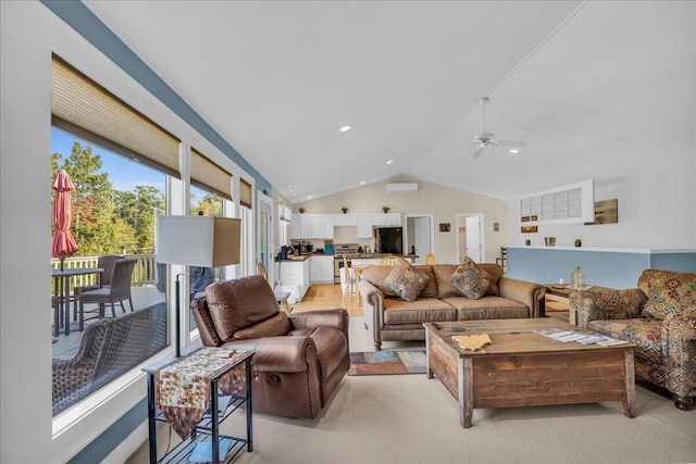 living room with ceiling fan, light wood-type flooring, and vaulted ceiling