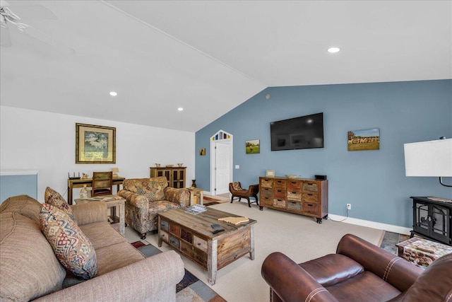 living room featuring lofted ceiling, ceiling fan, and light carpet