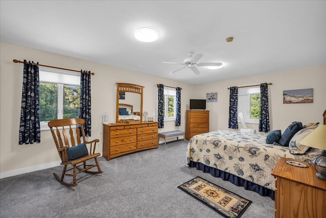 bedroom with multiple windows, ceiling fan, and carpet floors