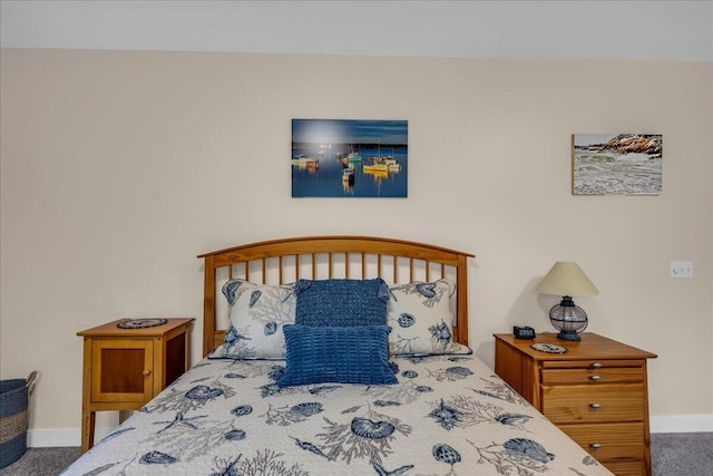 bedroom with dark colored carpet