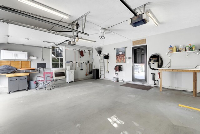 garage featuring heating unit and a garage door opener