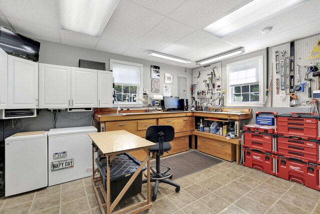 office space featuring washer and dryer, a workshop area, and a healthy amount of sunlight