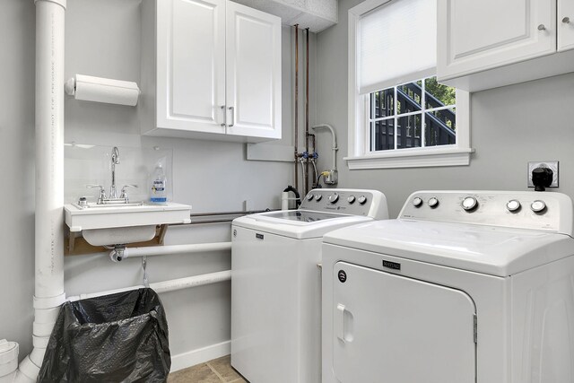 washroom with cabinets and washer and dryer