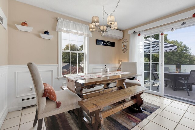 dining area featuring an inviting chandelier, baseboard heating, light tile patterned floors, and an AC wall unit