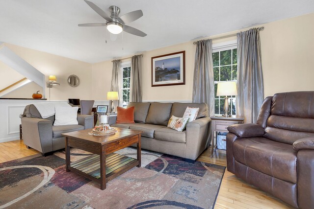 living room featuring ceiling fan and light hardwood / wood-style flooring