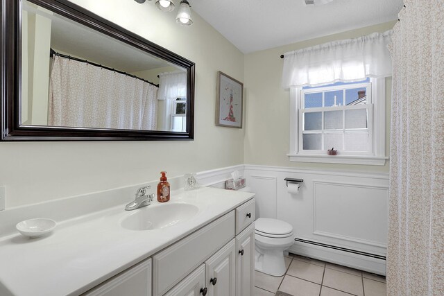 bathroom featuring a baseboard radiator, tile patterned flooring, vanity, and toilet