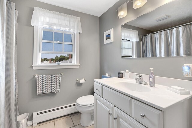 bathroom featuring a baseboard radiator, plenty of natural light, vanity, and toilet