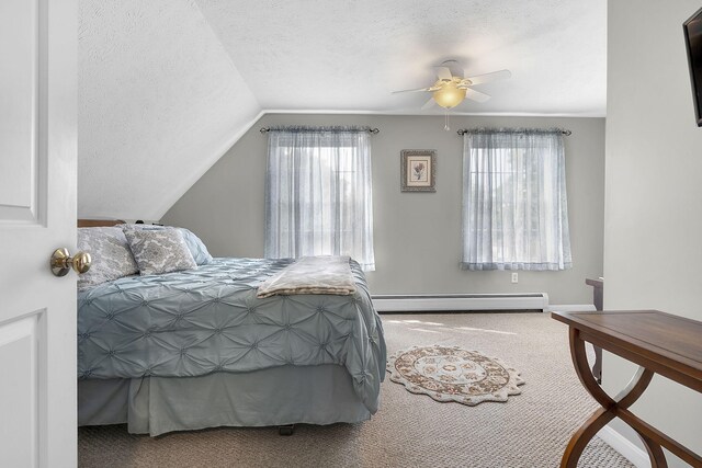 bedroom with multiple windows, lofted ceiling, baseboard heating, and ceiling fan