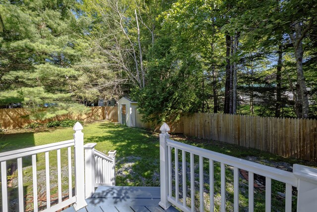 view of yard with a storage unit and a deck