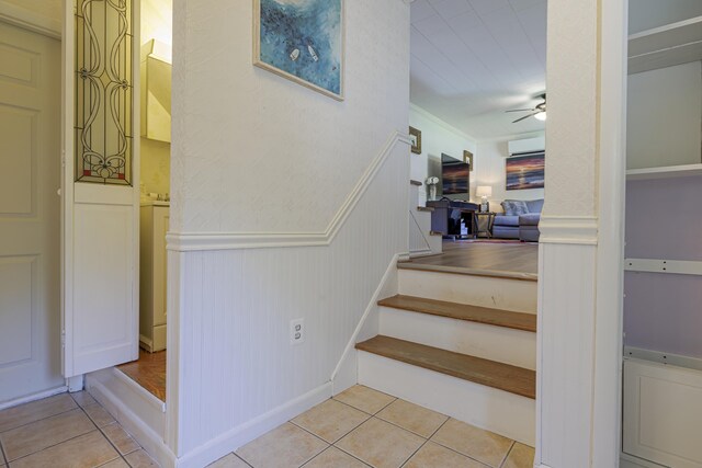 stairs with ceiling fan and tile patterned floors