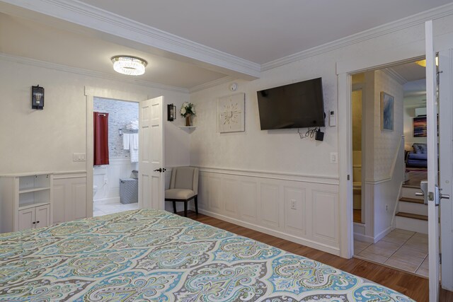 bedroom featuring hardwood / wood-style flooring and crown molding