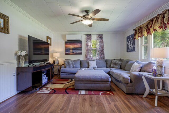 living room with crown molding, hardwood / wood-style flooring, an AC wall unit, and ceiling fan