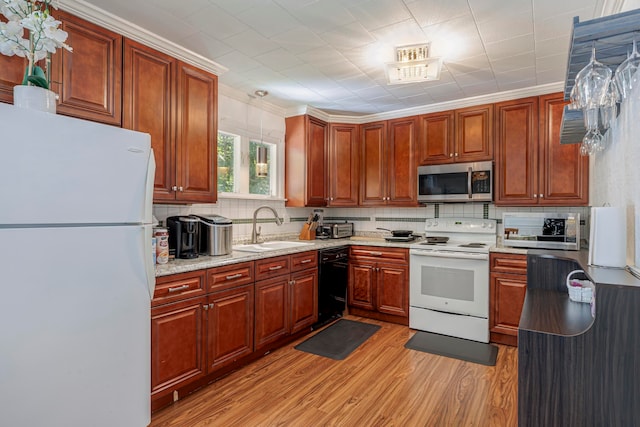 kitchen featuring light wood-type flooring, white appliances, tasteful backsplash, sink, and light stone countertops