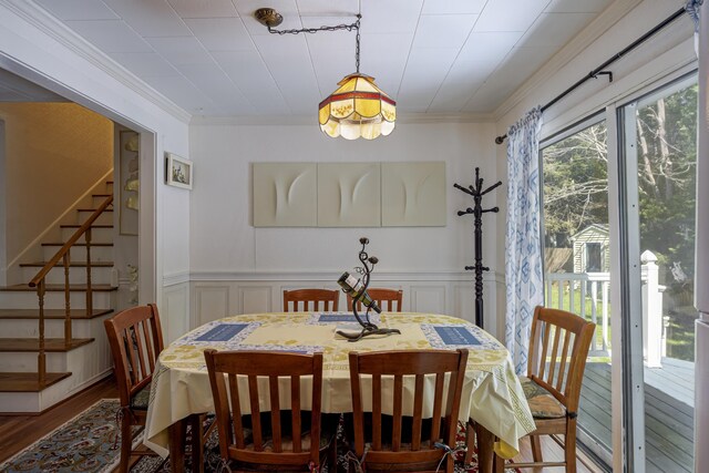 dining space featuring ornamental molding and wood-type flooring