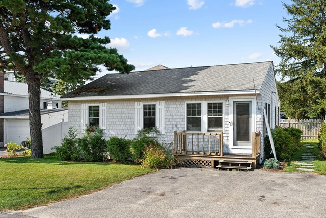 view of front of house with a garage and a front lawn