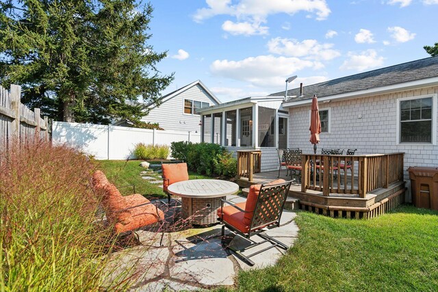 view of patio / terrace with a sunroom and a deck