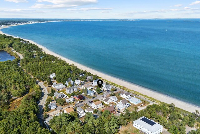 drone / aerial view featuring a water view and a view of the beach