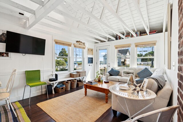 living room with dark wood-type flooring, a wealth of natural light, and vaulted ceiling with beams