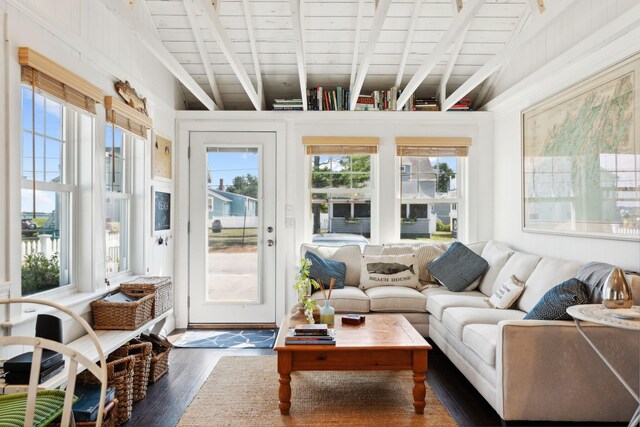 sunroom featuring wood ceiling and lofted ceiling with beams