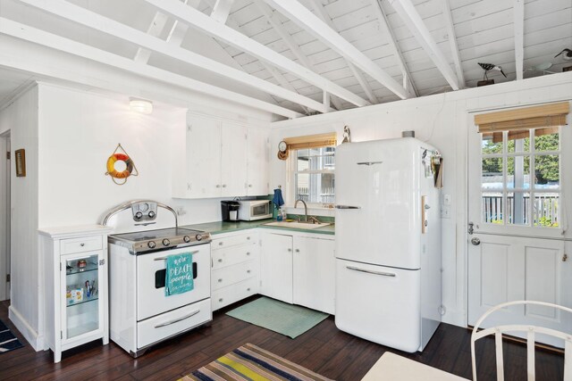 kitchen featuring white cabinets, white appliances, plenty of natural light, and sink