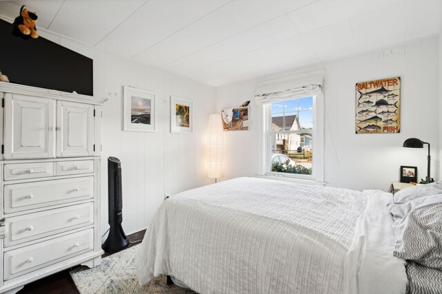 bedroom with wooden walls