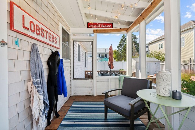 sunroom with lofted ceiling with beams