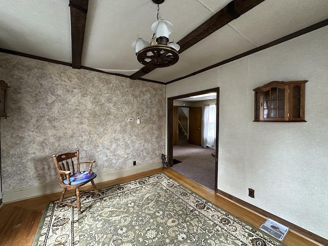 interior space with wood-type flooring, crown molding, beamed ceiling, and an inviting chandelier