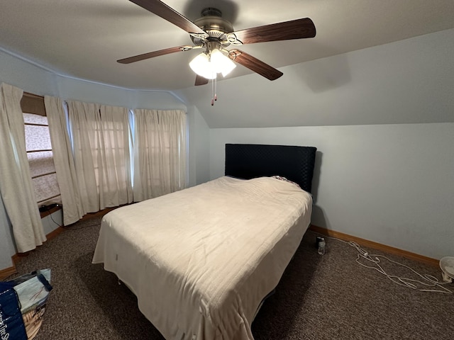 carpeted bedroom with ceiling fan and vaulted ceiling